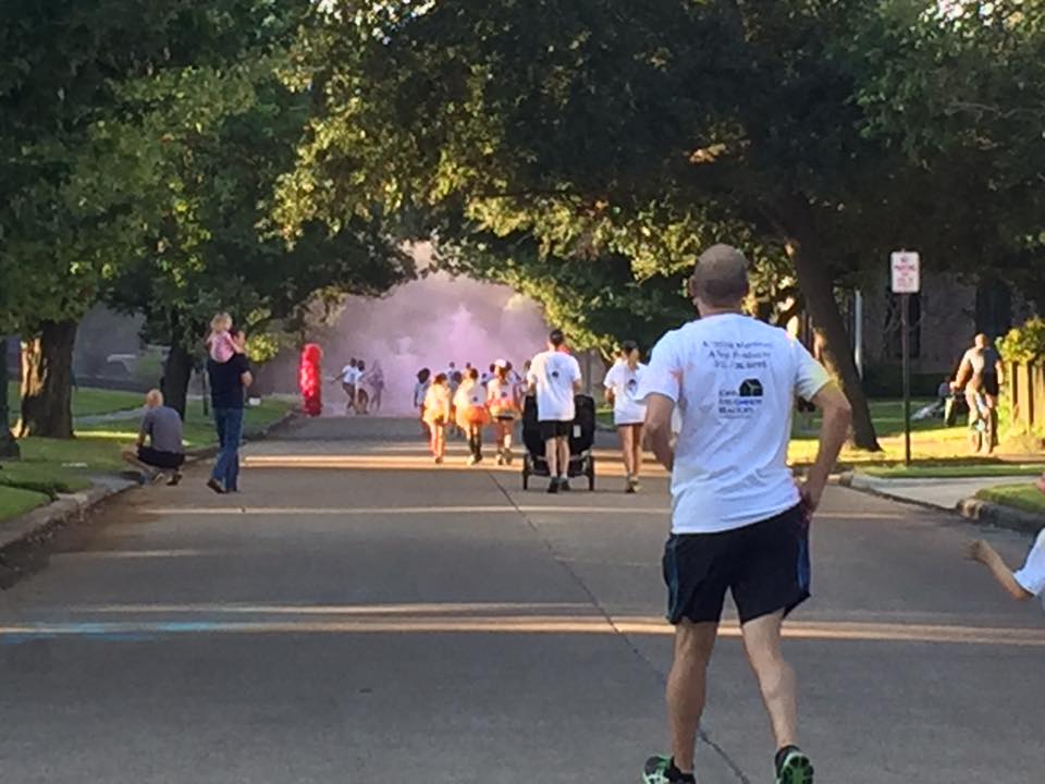 Runners approaching a cloud of colored powder